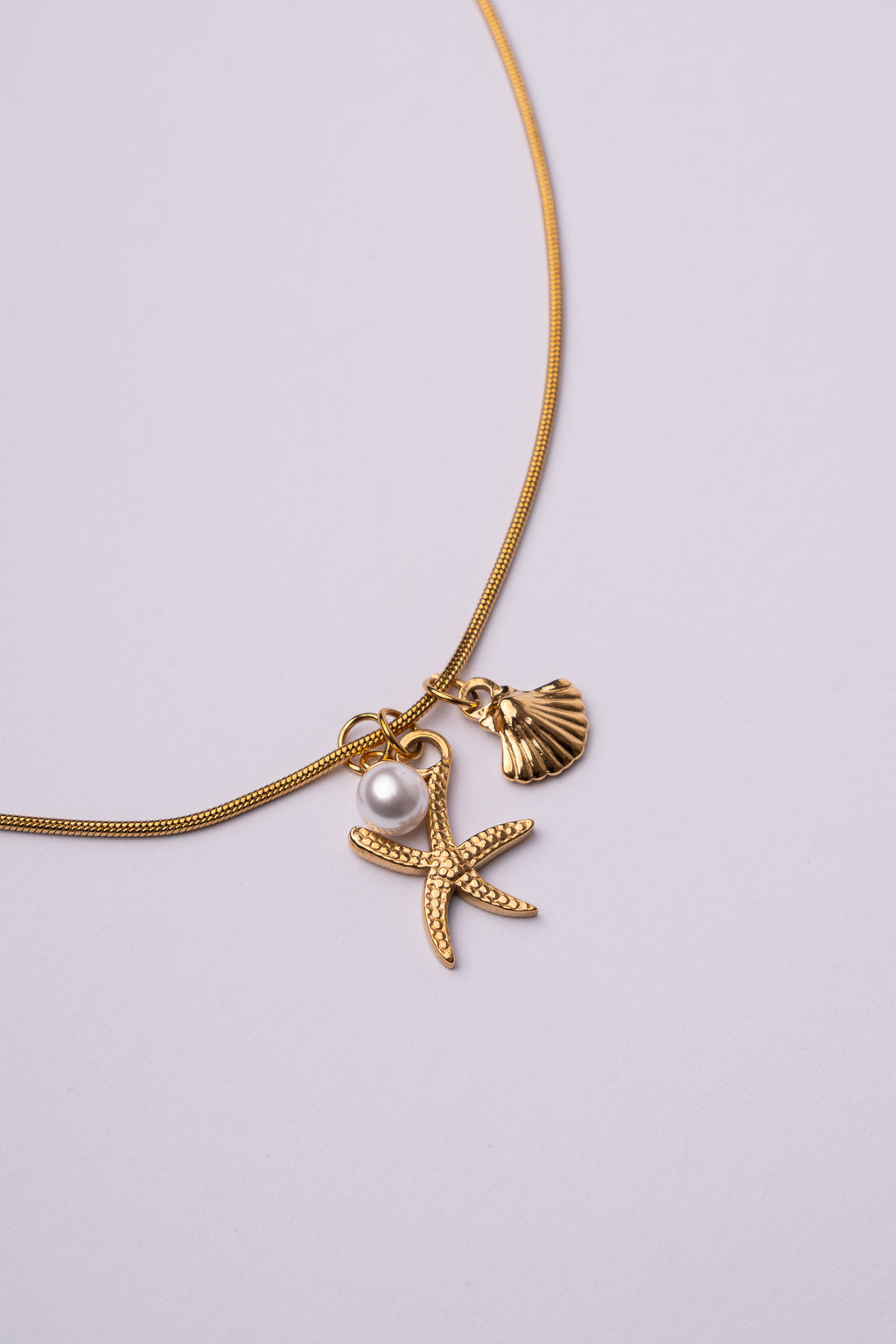 Collar estrella de mar y concha acero oro 18k mujer