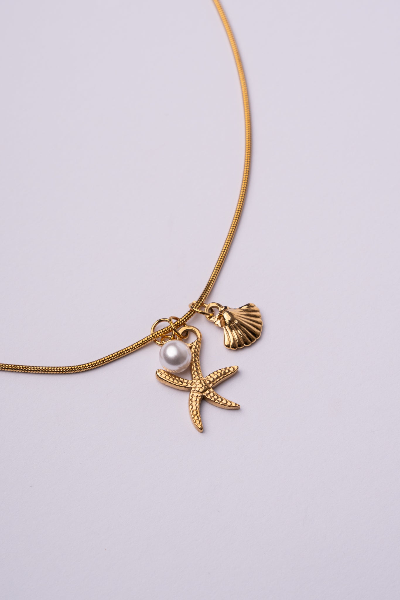 Collar estrella de mar y concha acero oro 18k mujer